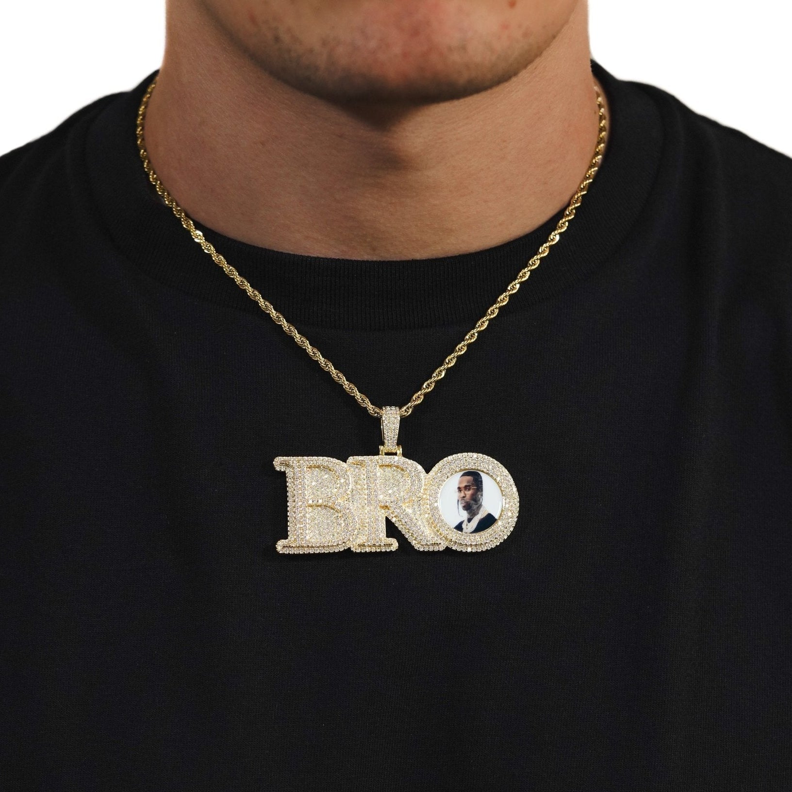 Male model wearing CRNCY's Large BRO Photo Pendant with a 14k gold finish and a 18 inch length necklace.