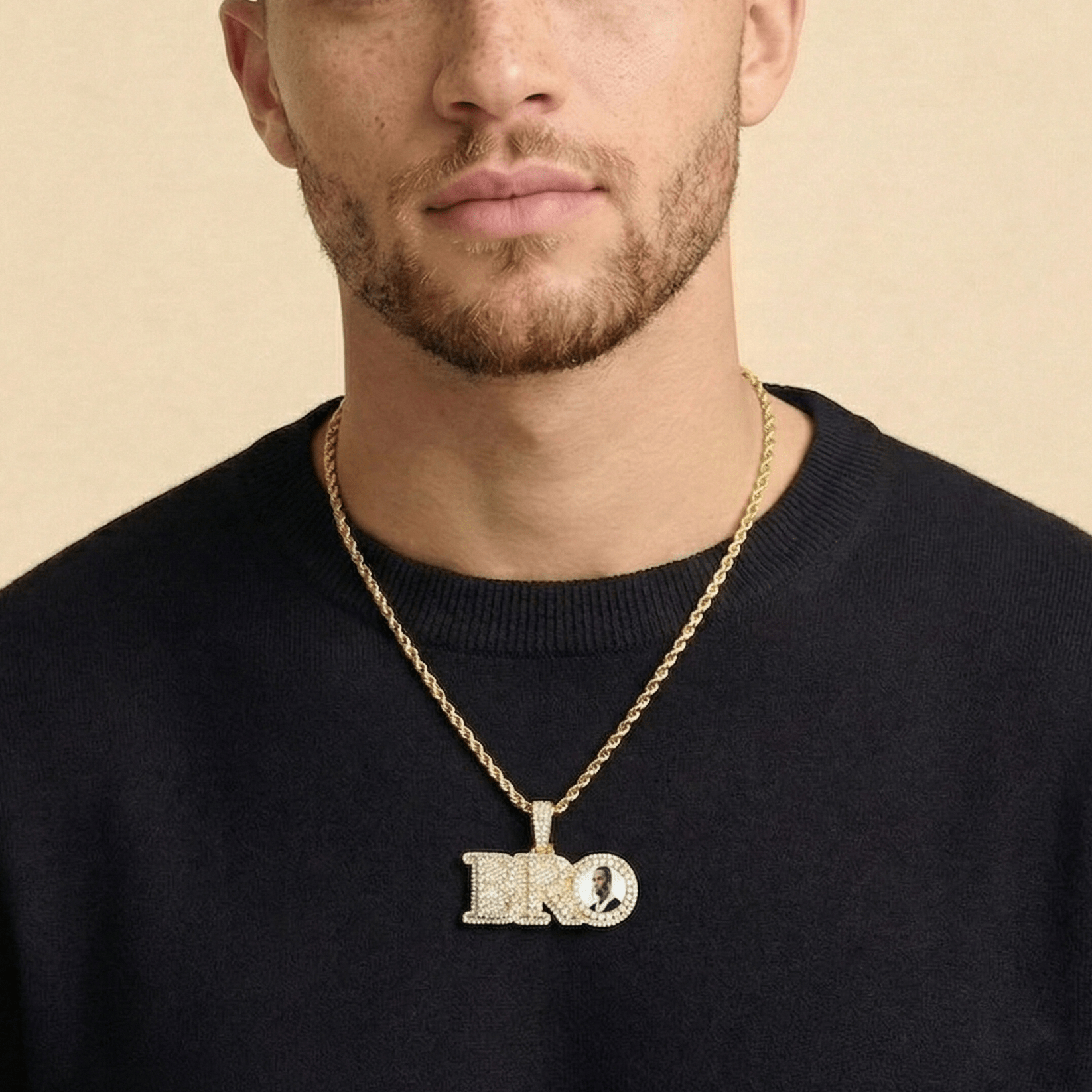 Male model wearing CRNCY's Small BRO Photo Pendant with a 14k gold finish and a 20 inch length necklace.
