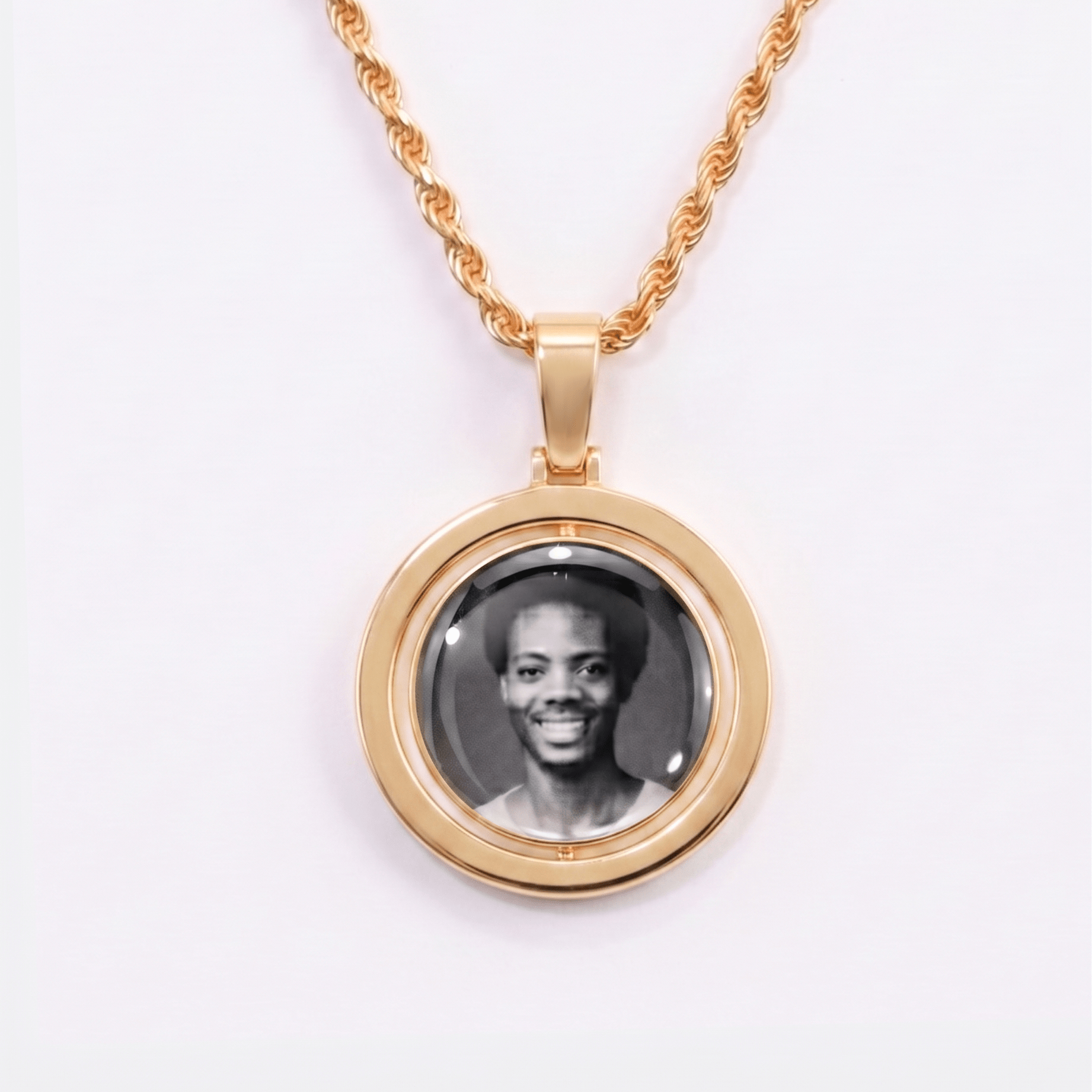 Back side of CRNCY's Double Sided Photo Pendant with a 14k gold finish. The backside has a polished finish without diamonds, allowing the pendant to be worn in a reversibly. The backside shows the back side photo choice.