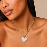 Female model wearing CRNCY's Brother Heart Photo Pendant with a 14k gold finish and a 16 inch length necklace.
