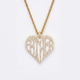 The front side of CRNCY's Father Heart Photo Pendant with a 14k gold finish. The front side features prong-set diamonds placed inside each letter, surrounded by colored jewelry enamel to outline the letters. 