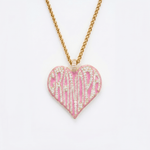 The front side of CRNCY's Grandpa Heart Photo Pendant with a 14k gold finish and pink jewelry enamel. The front side features prong-set diamonds placed inside each letter, surrounded by colored jewelry enamel to outline the letters. 
