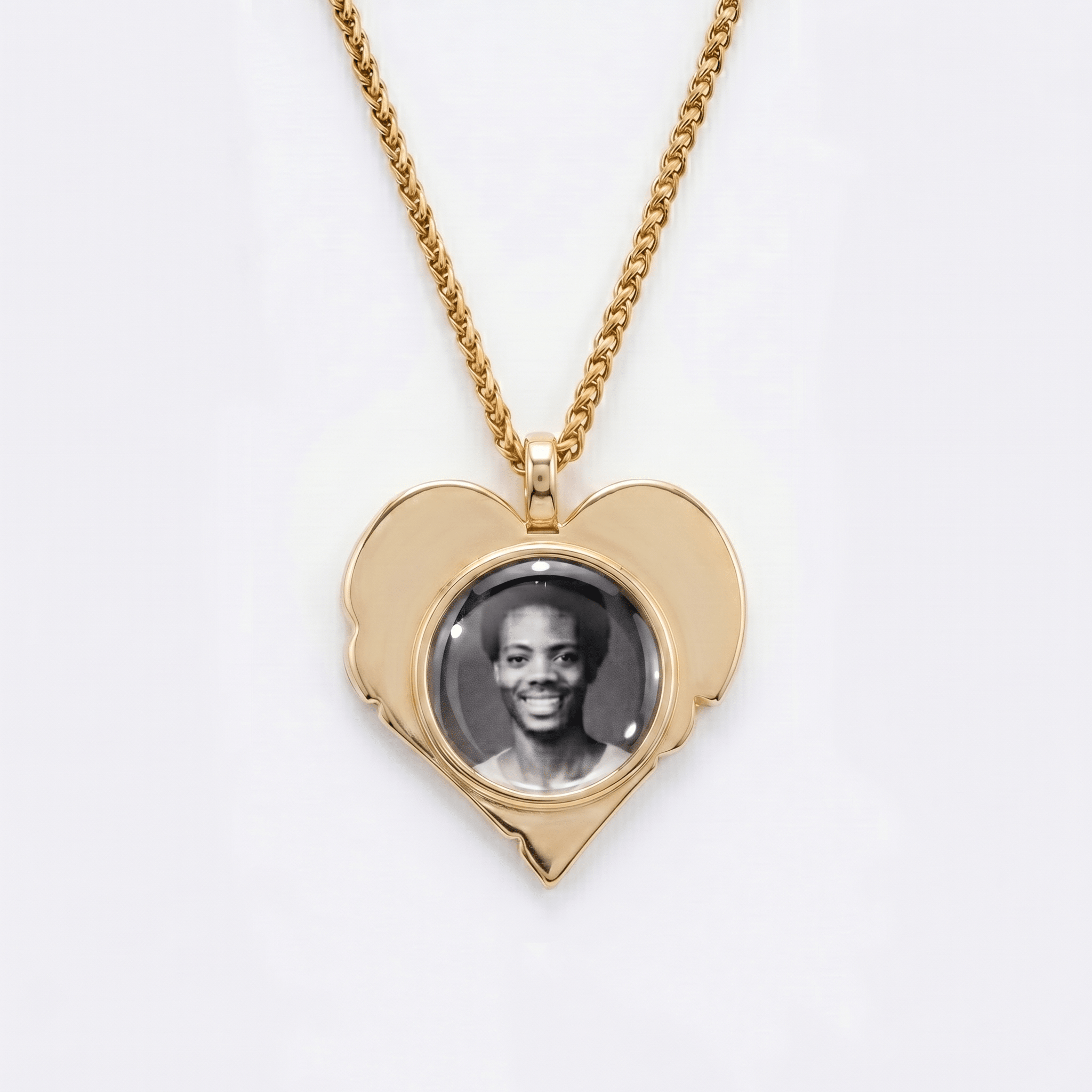 The back side of CRNCY's Grandpa Heart Photo Pendant. The back side has a polished appearance with a circular photo place directly in the center. The photo is selected by the customer.