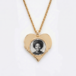 The back side of CRNCY's Mom Heart Photo Pendant. The back side has a polished appearance with a circular photo place directly in the center. The photo is selected by the customer.