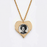 The back side of CRNCY's Mom Heart Photo Pendant. The back side has a polished appearance with a circular photo place directly in the center. The photo is selected by the customer.