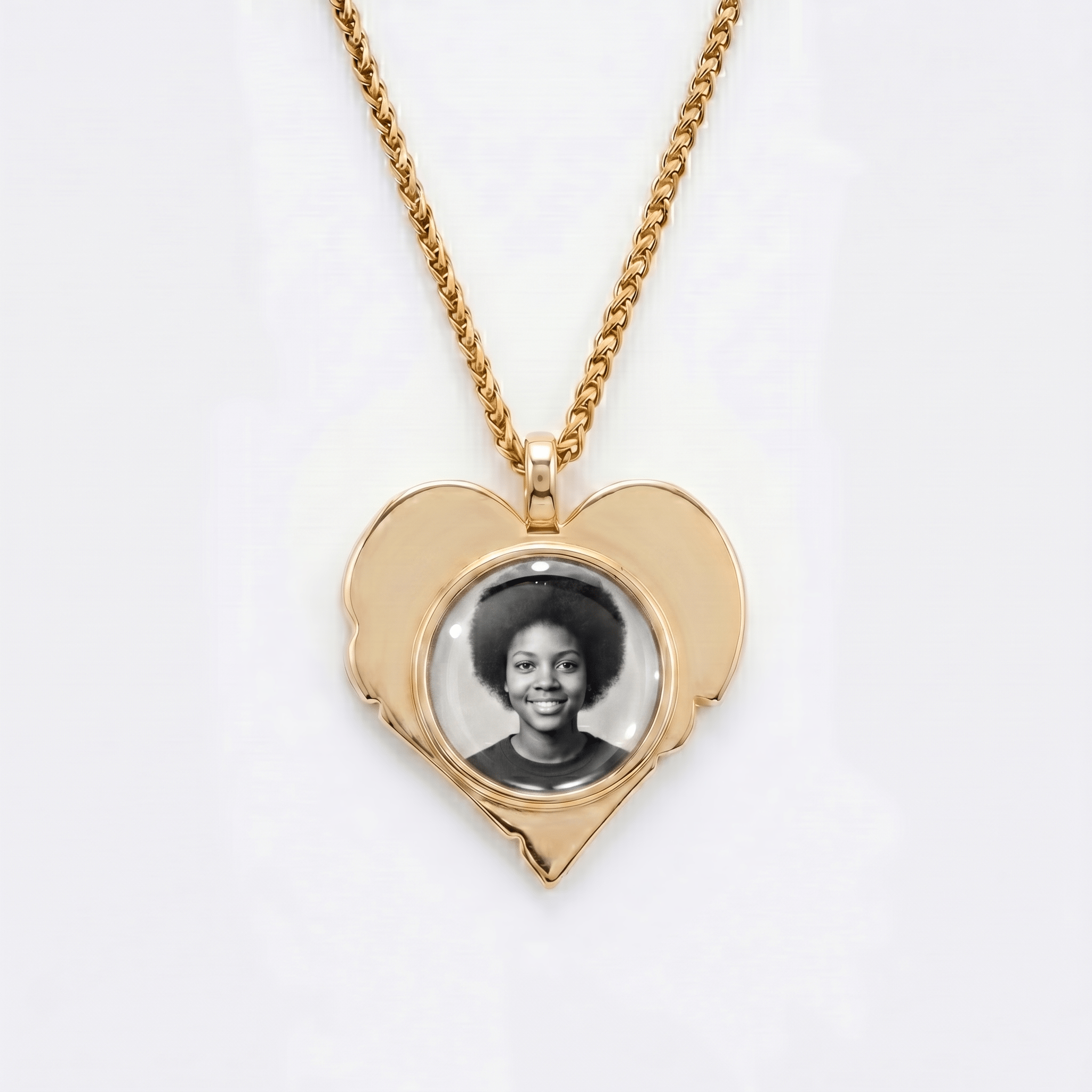 The back side of CRNCY's Mom Heart Photo Pendant. The back side has a polished appearance with a circular photo place directly in the center. The photo is selected by the customer.