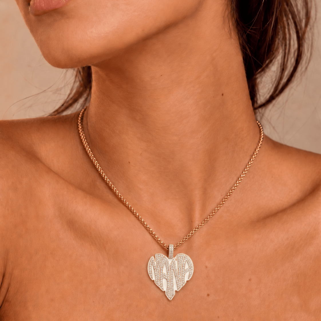 Female model wearing CRNCY's Nana Heart Photo Pendant with a 14k gold finish and a 16 inch length necklace.
