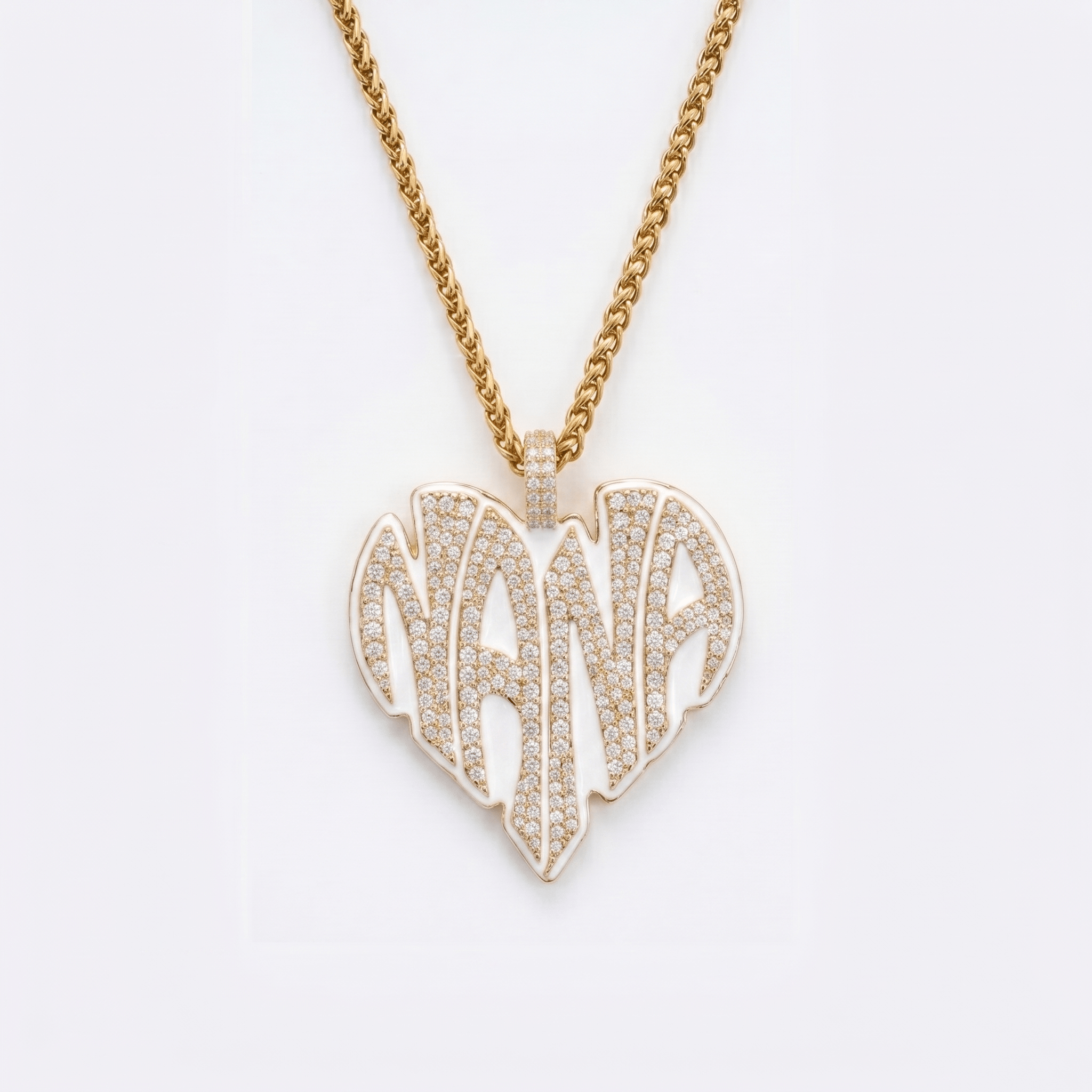 The front side of CRNCY's Nana Heart Photo Pendant with a 14k gold finish and white jewelry enamel. The front side features prong-set diamonds placed inside each letter, surrounded by colored jewelry enamel to outline the letters. 