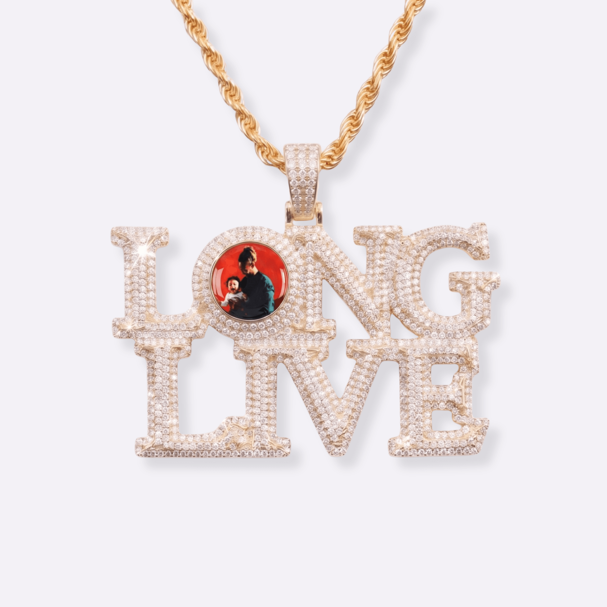 The front side of CRNCY's LONG LIVE Photo Pendant with a 14k gold finish. The front side features prong-set diamonds around the photo, on each letter, and on the bale. The front side shows the customer's photo selection inside the "O" of the "LONG LIVE" name.