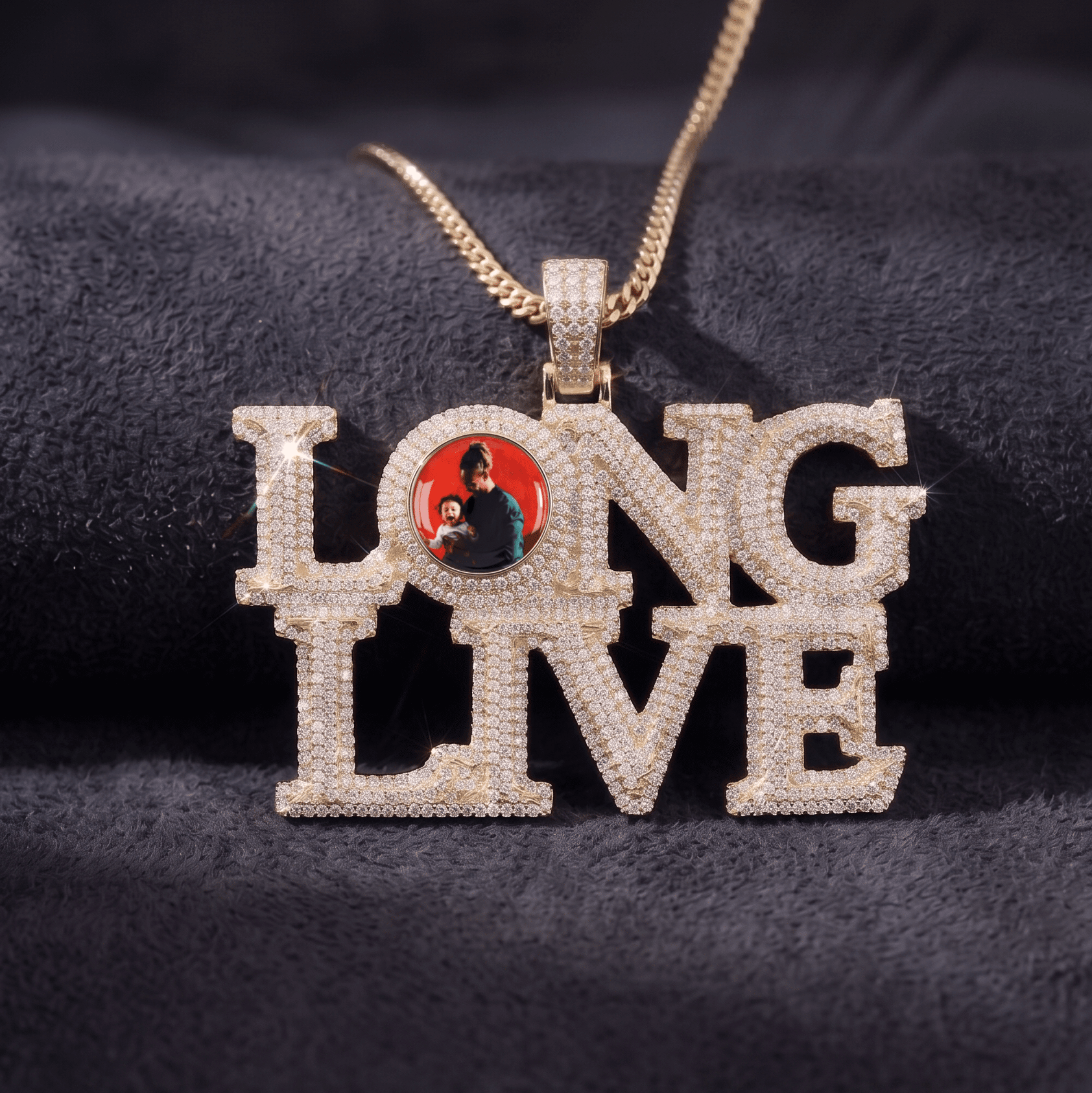 The front side of CRNCY's LONG LIVE Photo Pendant with a 14k gold finish. The front side features prong-set diamonds around the photo, on each letter, and on the bale. The front side shows the customer's photo selection inside the "O" of the "LONG LIVE" name.