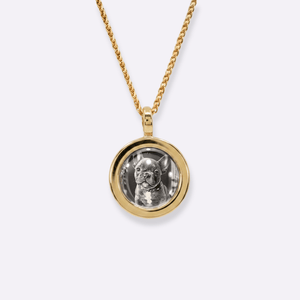 The front side of CRNCY's Mini Photo Pendant with a 14k gold finish. The front side features a polished appearance around the photo and on the bale. The front side shows the customer's photo selection.