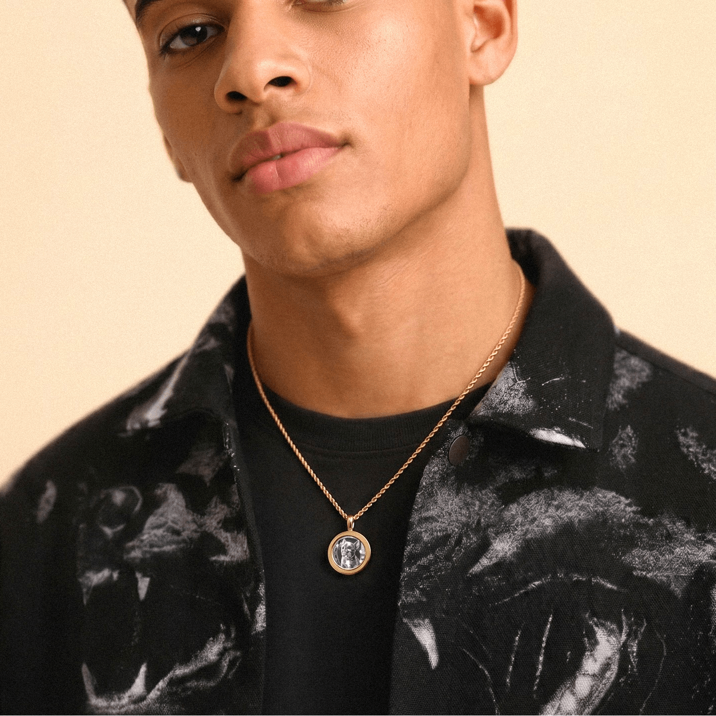Male model wearing CRNCY's Mini Photo Pendant with a 14k Gold Finish, with a 18 inch length necklace.