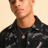 Male model wearing CRNCY's Mini Photo Pendant with a 14k Gold Finish, with a 18 inch length necklace.