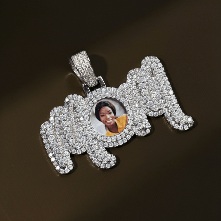 The front side of CRNCY's MOM Photo Pendant with a silver finish. The front side features prong-set diamonds around the photo and on the bale. The front side shows the customer's photo selection.