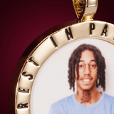 Close-up image of CRNCY's Rest In Paradise Photo Pendant. Focusing on the engraved words on the top of the photo pendant.