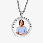 The front side of CRNCY's Watch Over Me Photo Pendant with a silver finish. The front side features a polished border around the photo. "Watch Over Me" is engraved on the upper half of the photo pendant, filled with black jewelry enamel. The front side shows the customer's photo selection. 