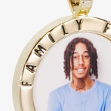 Close-up image of CRNCY's Family First Photo Pendant. Focusing on the engraved words on the top of the photo pendant.