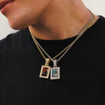 Male model wearing CRNCY's Small Framed Photo Pendant one with a 14k Gold Finish, and one with a silver finish. Both pendants are paired with 18 inch length necklaces.